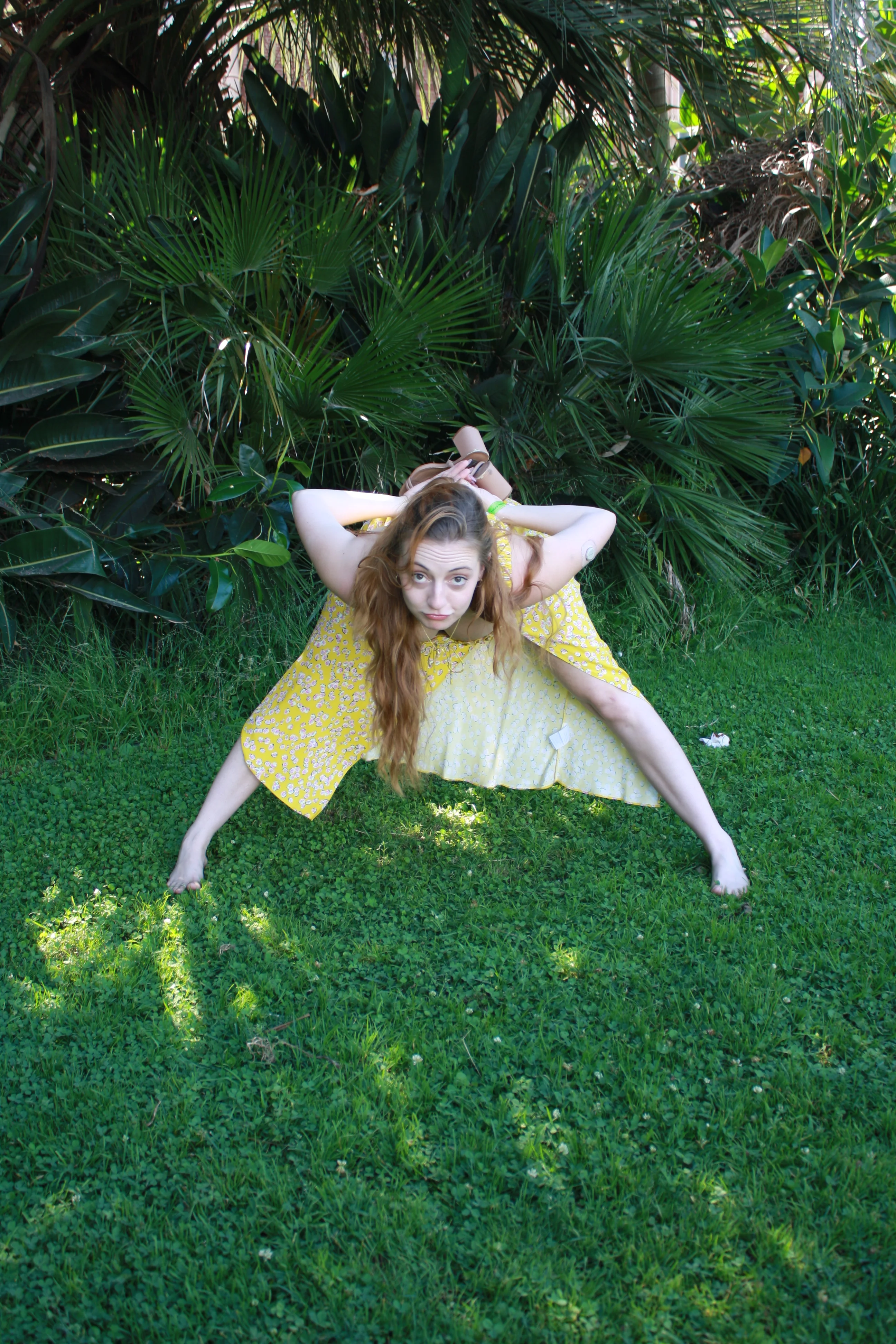 Jordie Morris bending forward in a wide-legged pose on the lawn at the Exposition Park Rose Garden.